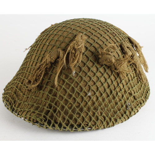 1235 - WW2 scarce 1944 dated 1944 pattern tortoise shell helmet with camo cover.