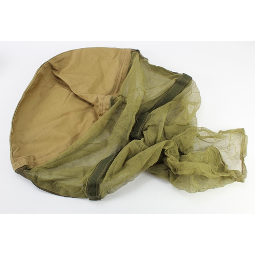 1238 - WW2 scarce unissued 1944 dated helmet cover with mosquito net.