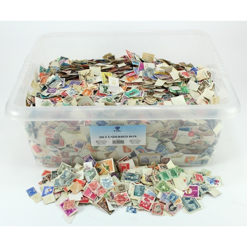 153 - Large clear crate housing tens of thousands of loose off paper stamps from around the World, little ... 