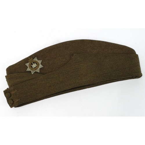 2376 - Devonshire Regiment badged side cap, stamped inside with the W/D crows foot and dated 1943 or 5. Mak... 