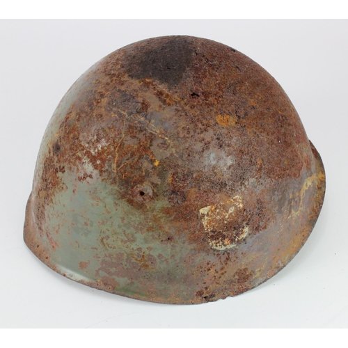 2453 - Italian combat Helmet in ground dug condition with remnants of SS decal.