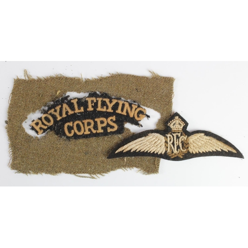 2595 - RFC interest a pair of Pilots wings and a worn other ranks shoulder title.