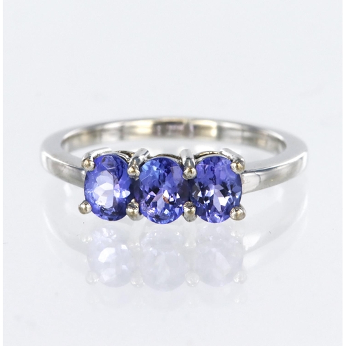10 - 14ct white gold ring set with three oval tanzanites totalling 1.16ct (stamped in shank), finger size... 