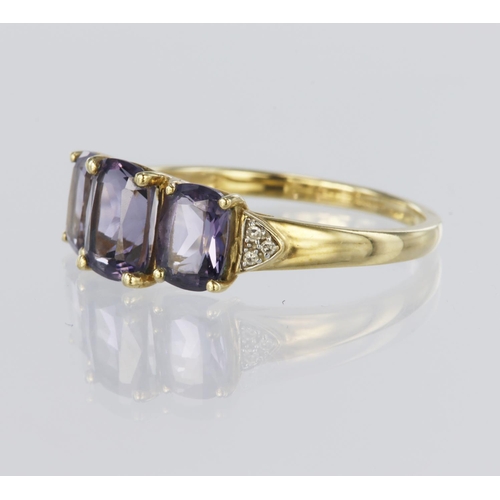 112 - 9ct yellow gold ring set with three rectangular iolites, centre stone measuring approx. 8mm x 6mm, a... 