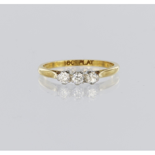 117 - 18ct yellow gold and platinum trilogy ring, set with three round brilliant cut diamonds totalling ap... 