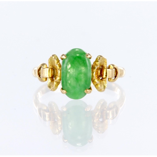 22 - 14ct yellow gold ring set with an elongated oval jadeite measuring approx. 10mm x 6mm, with decorati... 