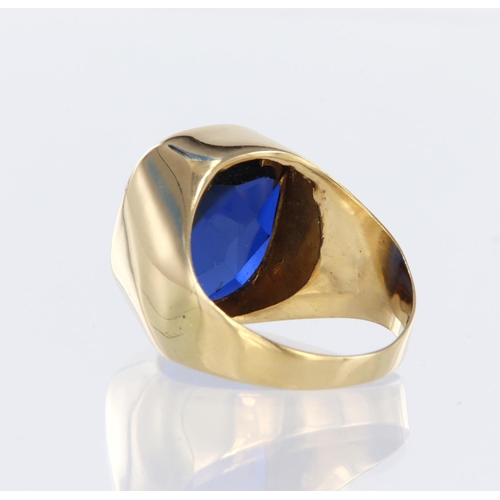 23 - 18ct yellow gold signet ring set with a rectangular reverse faceted blue stone with a shallow caboch... 