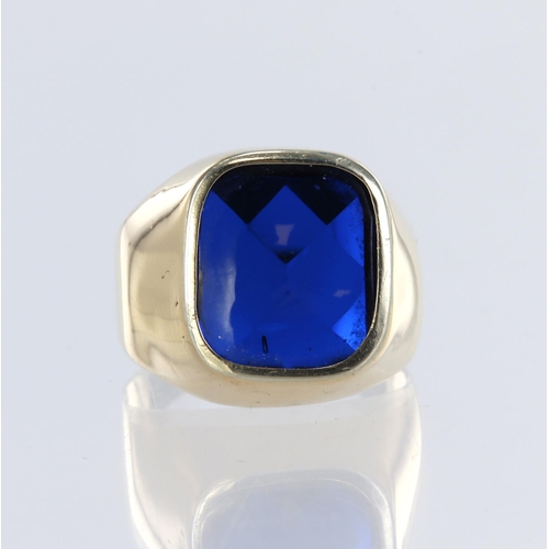 23 - 18ct yellow gold signet ring set with a rectangular reverse faceted blue stone with a shallow caboch... 