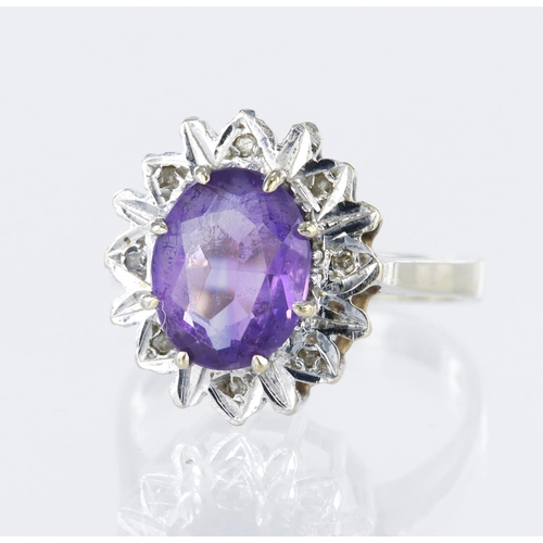 25 - 9ct yellow gold cluster dress ring set with a central oval amethyst measuring approx. 10mm x 8mm sur... 