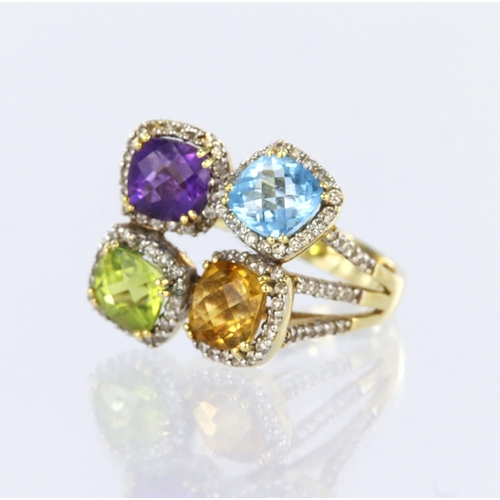 28 - 18ct yellow gold dress ring comprising four clusters set with amethyst, blue topaz, peridot and citr... 