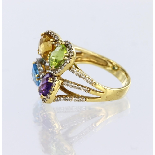 28 - 18ct yellow gold dress ring comprising four clusters set with amethyst, blue topaz, peridot and citr... 