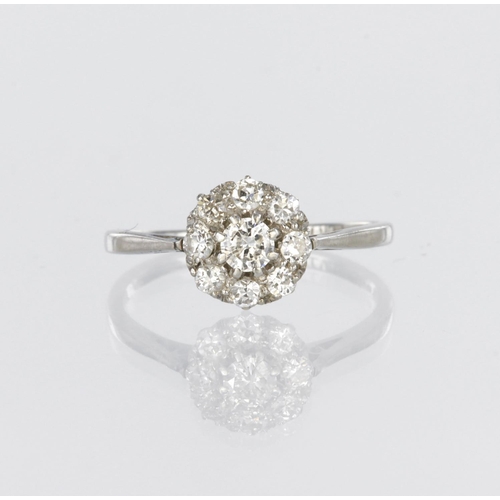 29 - 18ct white gold and platinum daisy cluster ring set with nine round brilliant cut diamonds, centre d... 
