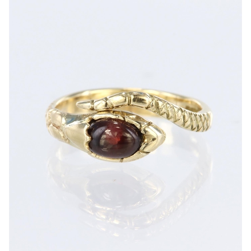 32 - 9ct yellow gold snake ring set with an oval garnet cabochon measuring approx. 6mm x 5mm, finger size... 