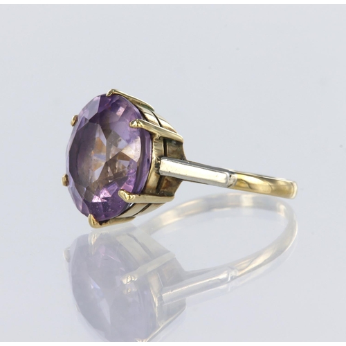 52 - 9ct yellow gold ring set with a round amethyst measuring approx. 14mm diameter in an six claw settin... 