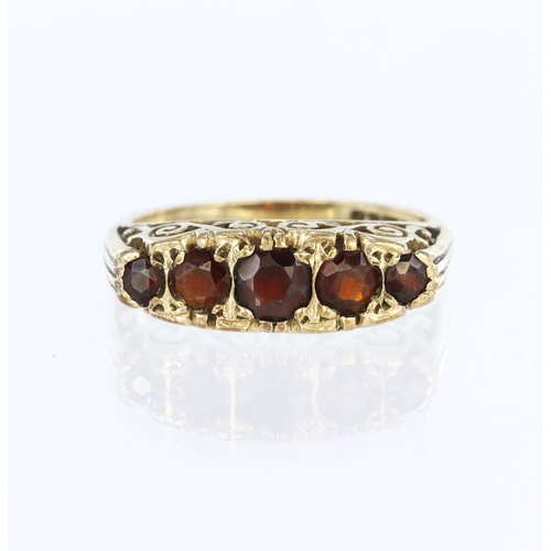 53 - 9ct yellow gold carved head ring set with five graduated round garnets ranging from 4.5mm to 2.5mm d... 