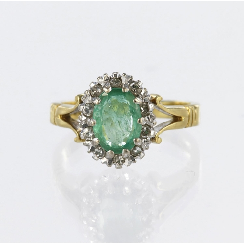 54 - 18ct yellow gold cluster ring featuring a central oval emerald measuring approx. 7mm x 5.5mm, surrou... 