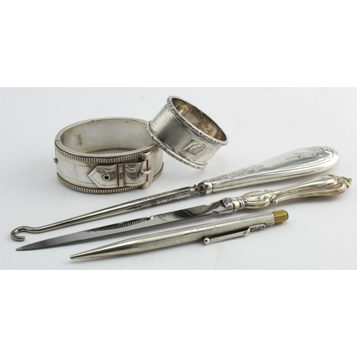 568 - Mixed lot of silver items comprising a silver bangle (hallmarked Birm. 1882); a silver napkin ring; ... 