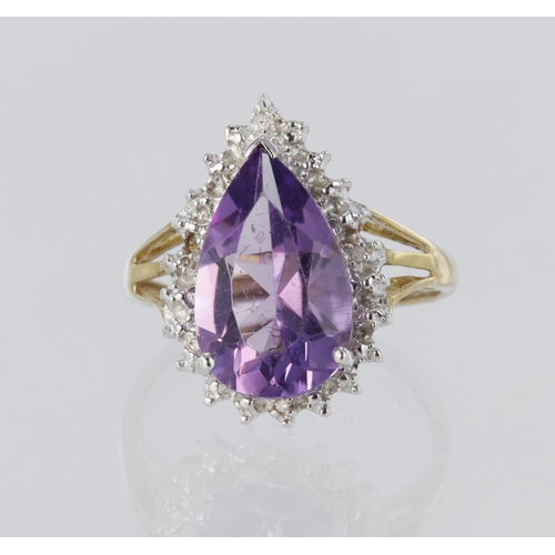 57 - 9ct yellow gold cluster dress ring set with a central pear shaped amethyst measuring approx. 14mm x ... 