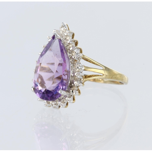 57 - 9ct yellow gold cluster dress ring set with a central pear shaped amethyst measuring approx. 14mm x ... 