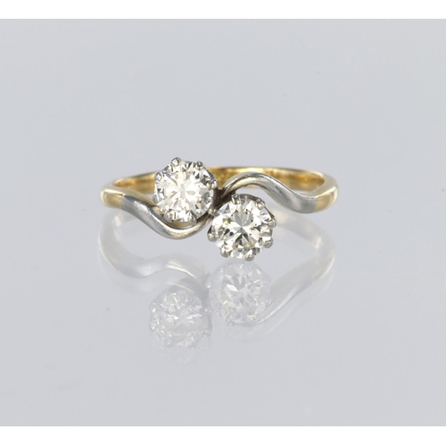 66 - 18ct yellow gold and platinum two stone crossover design ring set with two round brilliant cut diamo... 