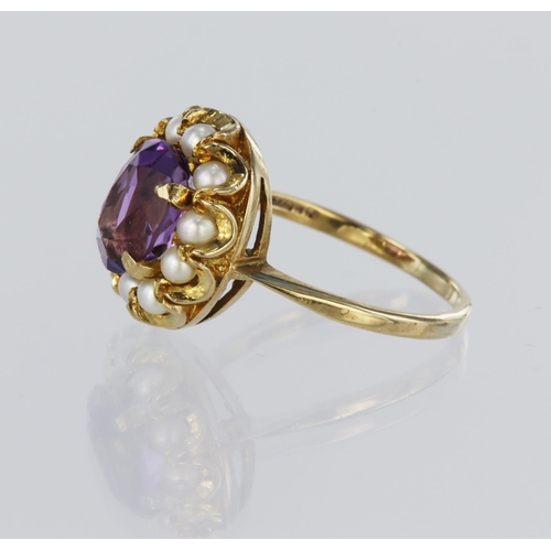 87 - 9ct yellow gold cluster ring featuring a central oval amethyst measuring approx. 10mm x 7mm, surroun... 