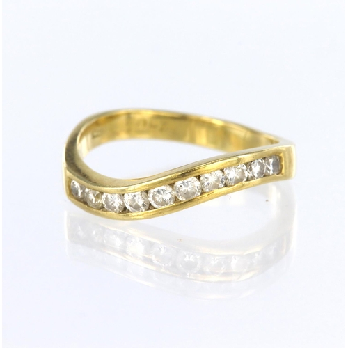 93 - 18ct yellow gold channel set half eternity ring of wave design, set with ten round brilliant cut dia... 