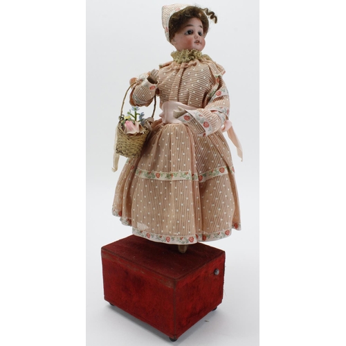 193 - Victorian German musical automaton bisque headed doll with glass eyes, key present, total height 42c... 