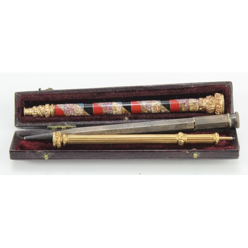 217 - Three propelling pencils, consisting of two yellow metal examples including one in morocco leather c... 