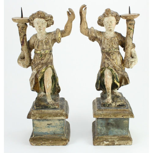 398 - Candlesticks. A pair of carved figural candlesticks, height 32.5cm approx.