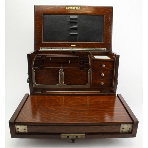 451 - Oak cased stationary box with two inkwells & folding writing slope, makers label for 'Army & Navy C.... 