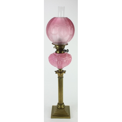 504 - Victorian brass oil lamp with cranberry glass shade, total height 80cm approx.