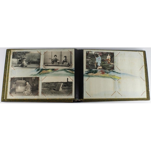 1099 - Black lacquer album with decorated pages, containing Japanese postcards   (approx 30)