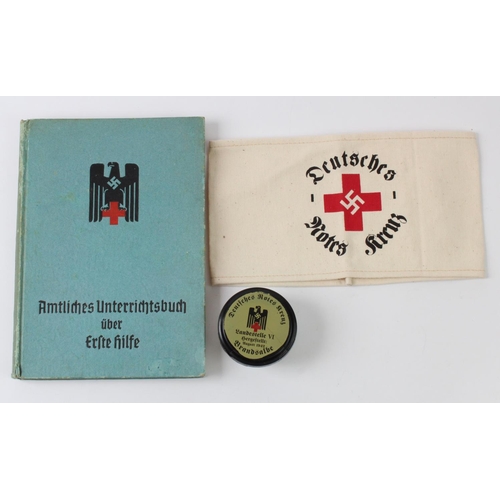 1595 - German 1942 Red Cross medical book with German Red Cross arm band and a jar of ointment.