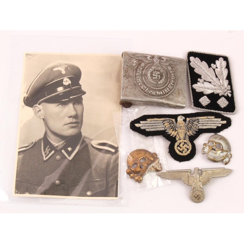 1797 - German SS cloth sleeve eagle, SS belt buckle, collar tab, SS hat badge and deaths head with a SS por... 