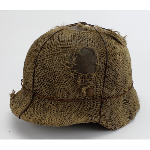 1809 - German steel combat helmet an unusual example, an M35 with hessian covering, complete with liner