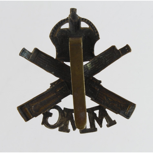 1890 - Badge a scarce MMG MGC cap badge