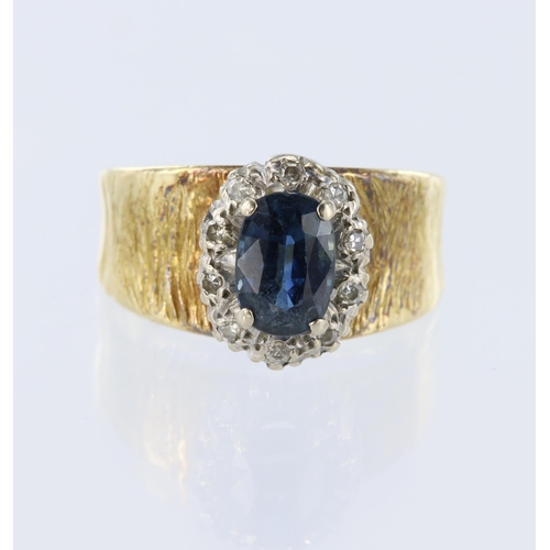 138 - 18ct yellow gold wide band cluster ring set with a cenral oval sapphire measuring approx. 7.5mm x 5.... 