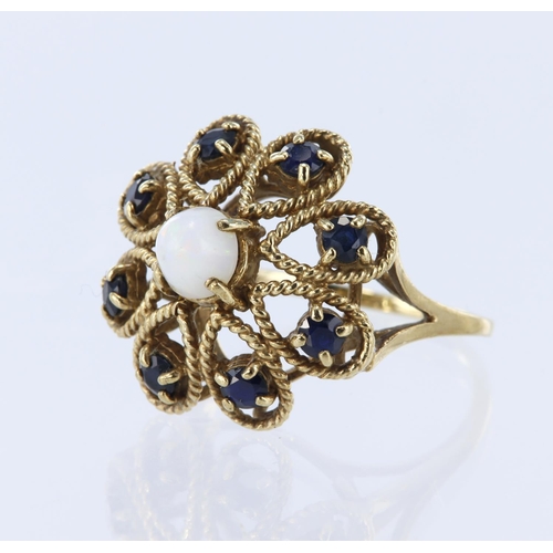 141 - 9ct yellow gold dress ring in a flower shape with a central opal cabochon measuring approx. 5mm diam... 