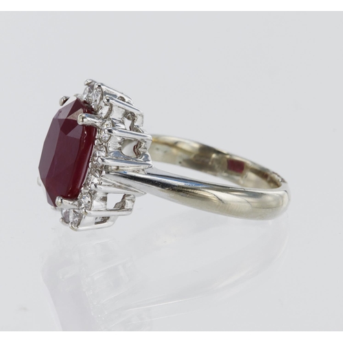 152 - 18ct white gold ring featuring a central ruby set in a four claw setting, weighing approx 5ct, surro... 