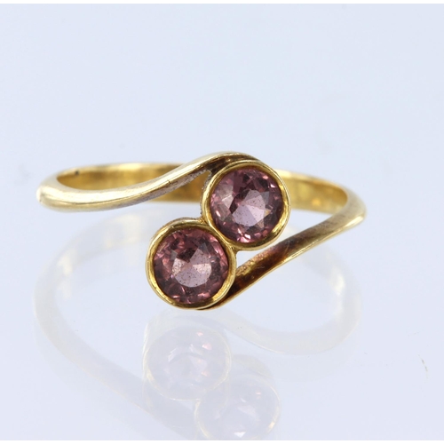 210 - 22ct yellow gold two stone crossover style ring set with two round pink tourmalines measuring approx... 