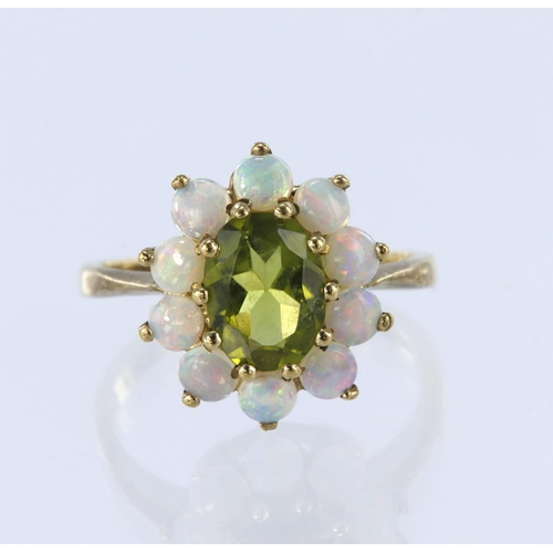 220 - 9ct yellow gold cluster ring set with a central oval peridot measuring approx. 8mm x 6m surrounded b... 