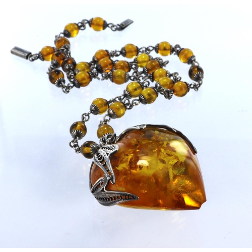 250 - Silver and amber necklace featuring a large heart pendant measuring approx. 45mm x 40mm with a silve... 