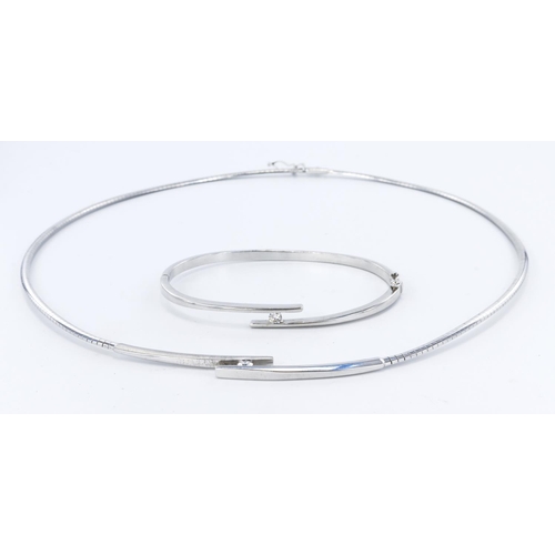 291 - 18ct white gold omega link collar with central solid panel in a crossover design with one half polis... 