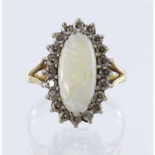 40 - 9ct yellow gold cluster ring set with a central elongated oval opal measuring approx. 15mm x 8mm, su... 