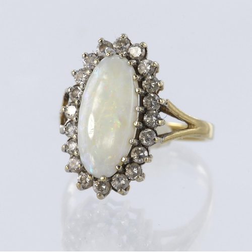 40 - 9ct yellow gold cluster ring set with a central elongated oval opal measuring approx. 15mm x 8mm, su... 