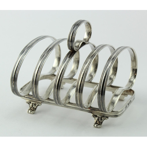 747 - Attractive, unusual silver toast rack on four scroll feet;   hallmarked JW&Co. 1937.  Weighs approx.... 