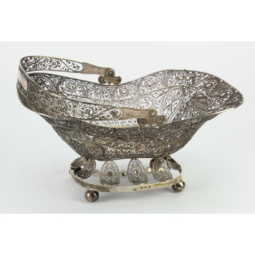 839 - Silver filigree basket with handle, on four ball feet, dutch hallmarked '1815', length 27cm approx.,... 