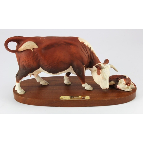 900 - Beswick Connoisseur. Hereford cow & calf by Beswick, mounted on a wooden plinth, height 16cm, length... 