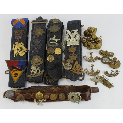 1149 - Cap badges - an original selection of mostly British Cap Badges displayed on RAF belts, plus a few l... 