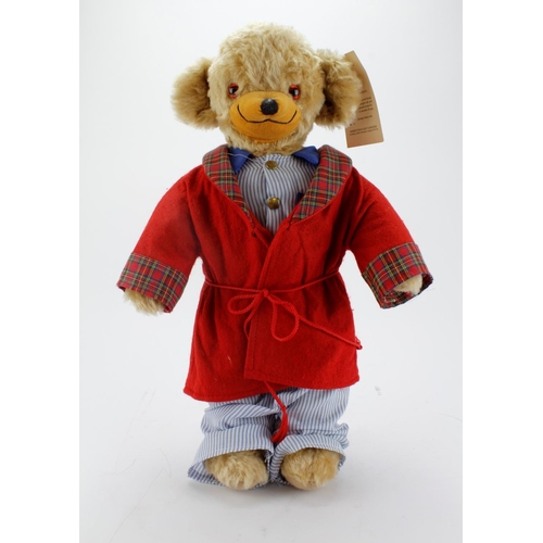 71 - Merrythought Mohair teddy bear wearing a dressing gown, original label to foot and tag in ear, heigh... 